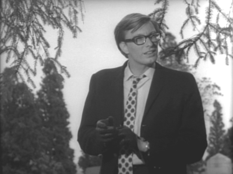 Actor and Image Ten member Russell Streiner in Night of the Living Dead. The image is in black and white. Streiner has glasses, blondish hair, and is wearing a dark suit with a patterned tie. 